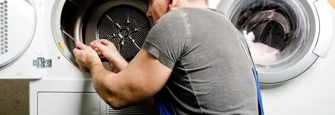 Dryer repair technician fixing a clothes dryer drum in San Francisco, CA