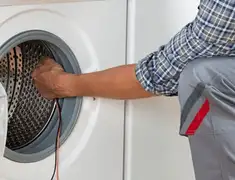 Dryer repair technician diagnosing and servicing a clothes dryer in San Francisco, CA