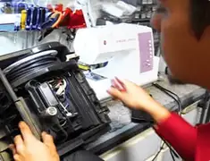 Vacuum repair technician servicing internal components on a workbench in San Francisco, CA